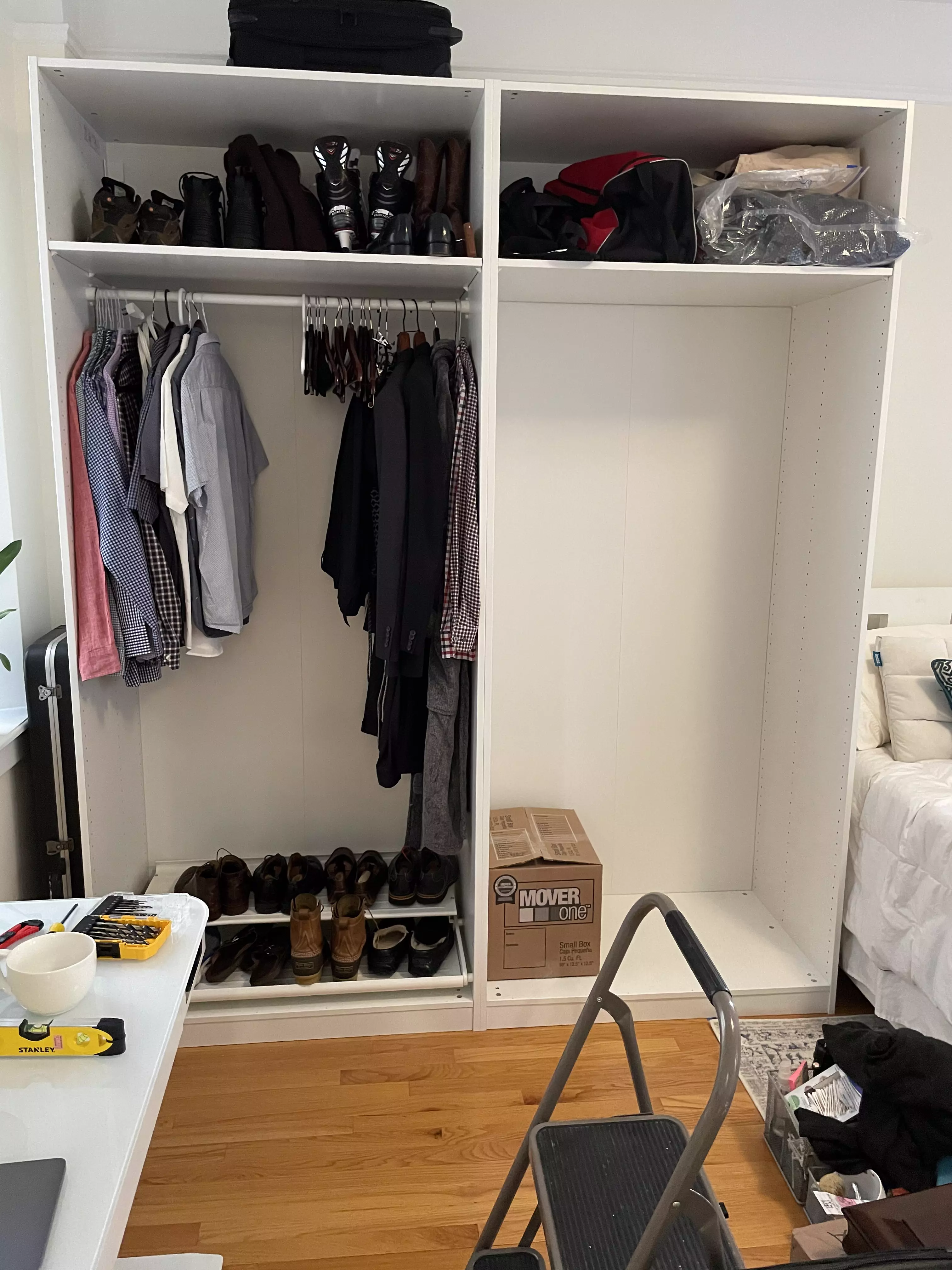 Put some of the accessories in: storage shelves, clothing rod, pull-out double-decker shoe tray. Aforementioned Stanley level and DeWalt drill bit set and coffee mug were also vital to this effort.